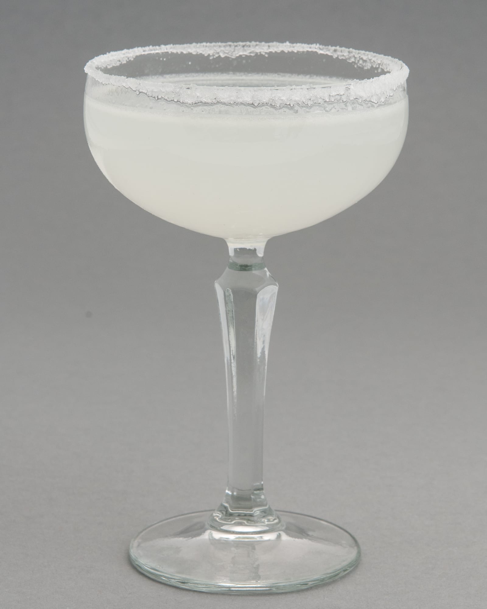 A classic margarita in a salt-rimmed coupe glass.