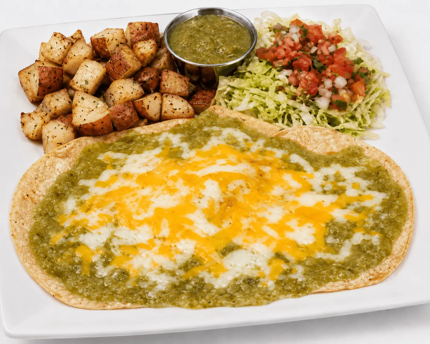 Huevos rancheros — eggs and tortillas smothered in red salsa, topped with crumbled queso fresco and onions.