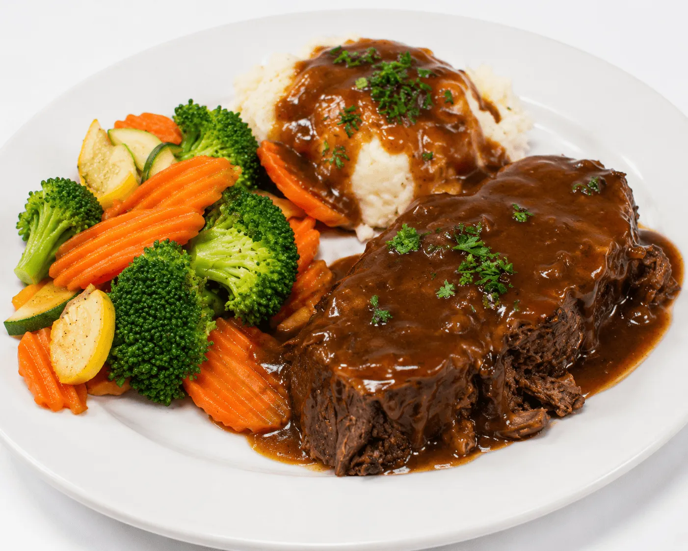 Pot Roast slow-cooked beef with mashed potatoes and seasonal vegetables
