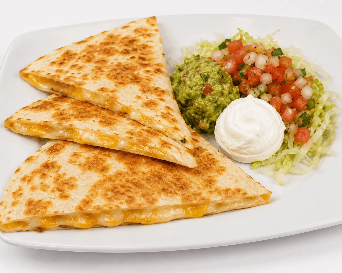 Quesadilla with melted cheese, pico de gallo, guacamole and sour cream