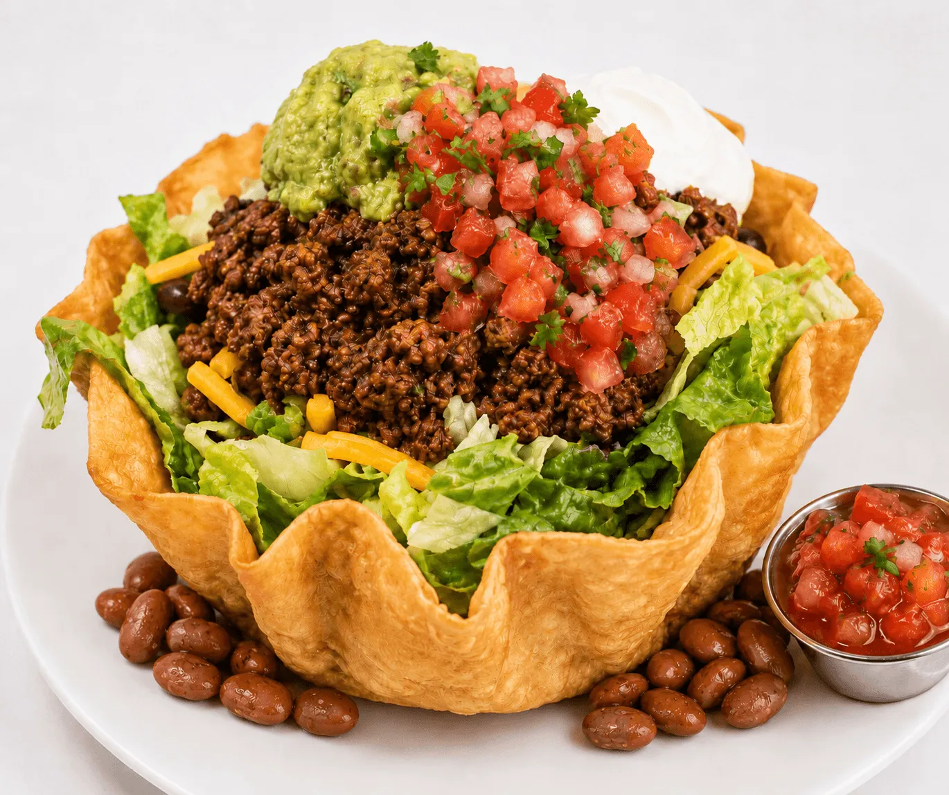 Taco Salad in a crispy flour tortilla bowl with ground beef, guacamole and mixed cheese