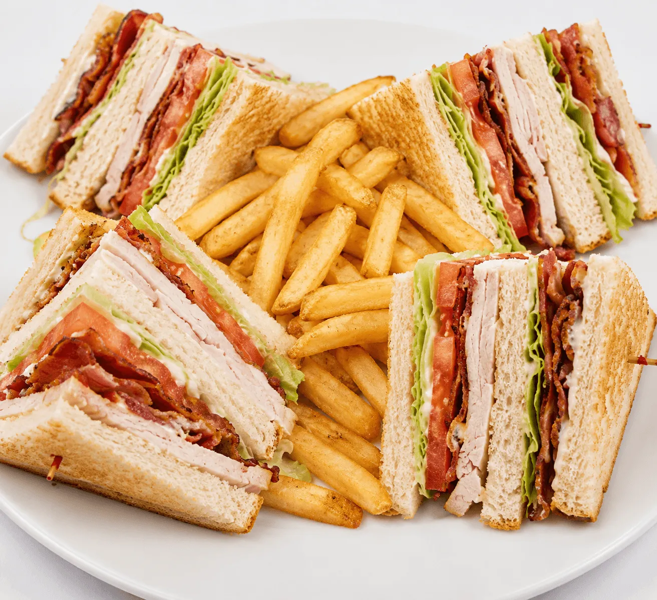Turkey Club Sandwich with turkey, bacon, lettuce and tomatoes on sourdough bread